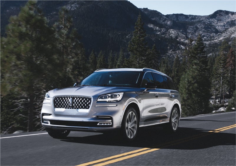 A 2023 Lincoln Aviator® Grand Touring SUV being driven on a winding road to demonstrate the capabilities of all-wheel drive | Al Packer Lincoln in West Palm Beach FL