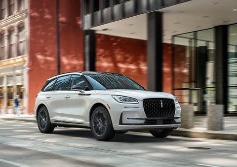 The 2024 Lincoln Corsair® SUV with the Jet Appearance Package and a Pristine White exterior is parked on a city street. | Al Packer Lincoln in West Palm Beach FL