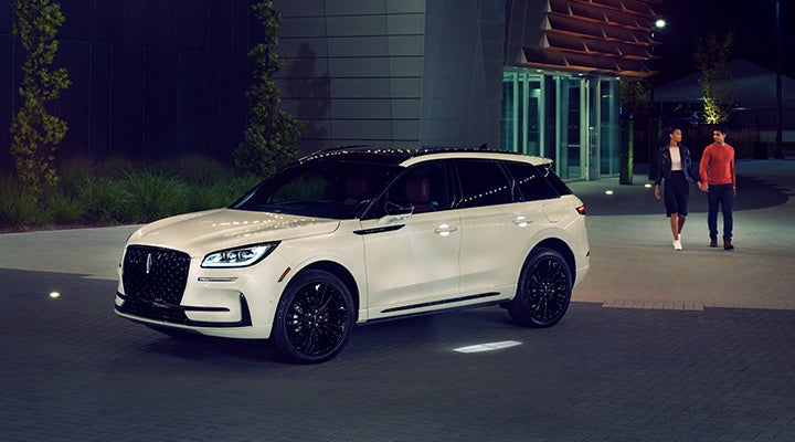 Two people approach a 2024 Lincoln Corsair® SUV featuring the available Jet Appearance Package. | Al Packer Lincoln in West Palm Beach FL