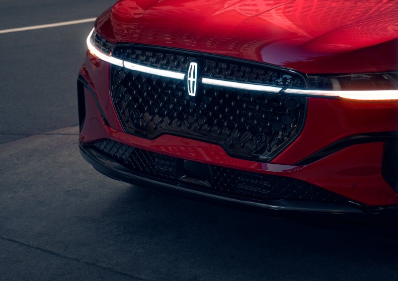 The available front LED light bar and center Lincoln Star logo glow at dusk. | Al Packer Lincoln in West Palm Beach FL