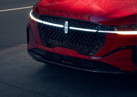 The available front LED light bar and center Lincoln Star logo glow at dusk. | Al Packer Lincoln in West Palm Beach FL