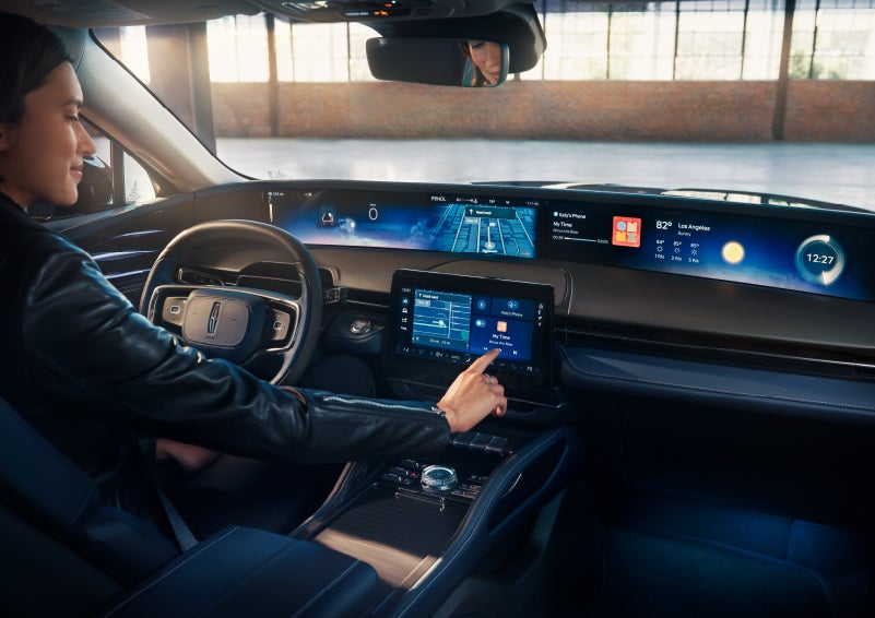 The driver of a 2025 Lincoln Nautilus® SUV interacts with the center touchscreen. | Al Packer Lincoln in West Palm Beach FL
