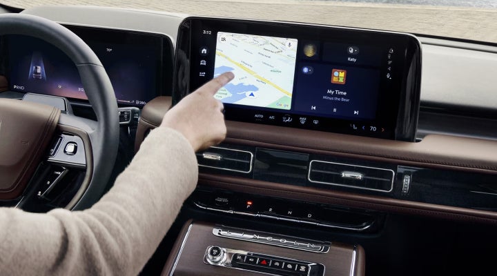 A person is tapping the center display touchscreen of a 2026 Lincoln Aviator® SUV. | Al Packer Lincoln in West Palm Beach FL