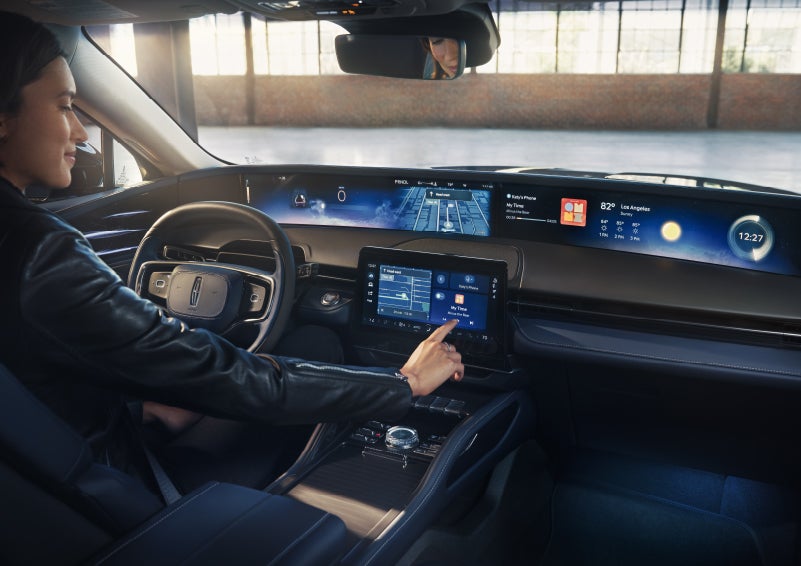 The driver of a 2026 Lincoln Nautilus® SUV interacts with the center touchscreen. | Al Packer Lincoln in West Palm Beach FL