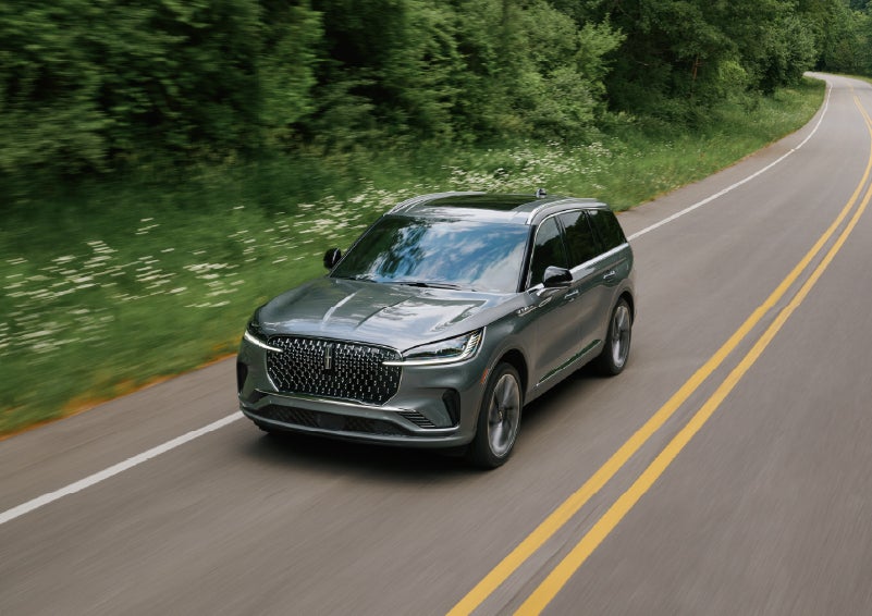 A 2027 Lincoln Aviator® SUV is being driven down a road. | Al Packer Lincoln in West Palm Beach FL