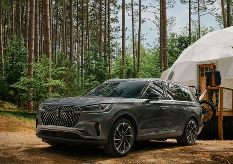 A 2027 Lincoln Aviator® is parked next to a high end glamping site. | Al Packer Lincoln in West Palm Beach FL