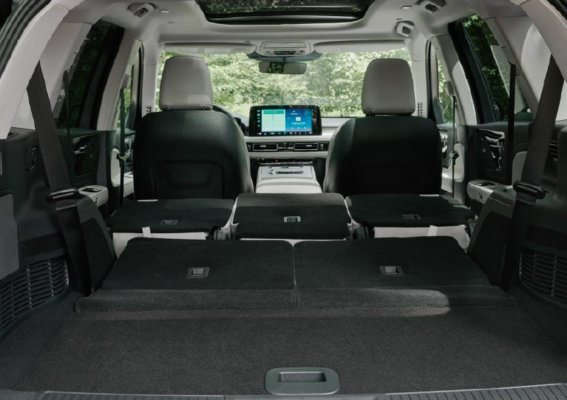 A rear to front view of the interior of a 2027 Lincoln Aviator® Black Label™ SUV shows the third and second rows folded flat | Al Packer Lincoln in West Palm Beach FL