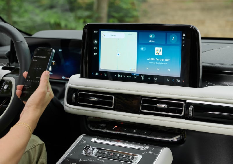 A person pairs thier phone with the center touchscreen of a 2027 Lincoln Aviator® Black Label™ SUV | Al Packer Lincoln in West Palm Beach FL