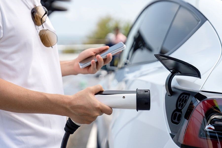 An EV being charged at a charging station